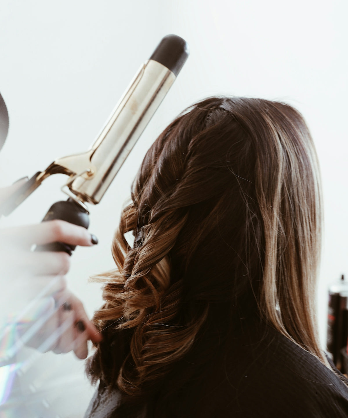 person holding gray hair curler