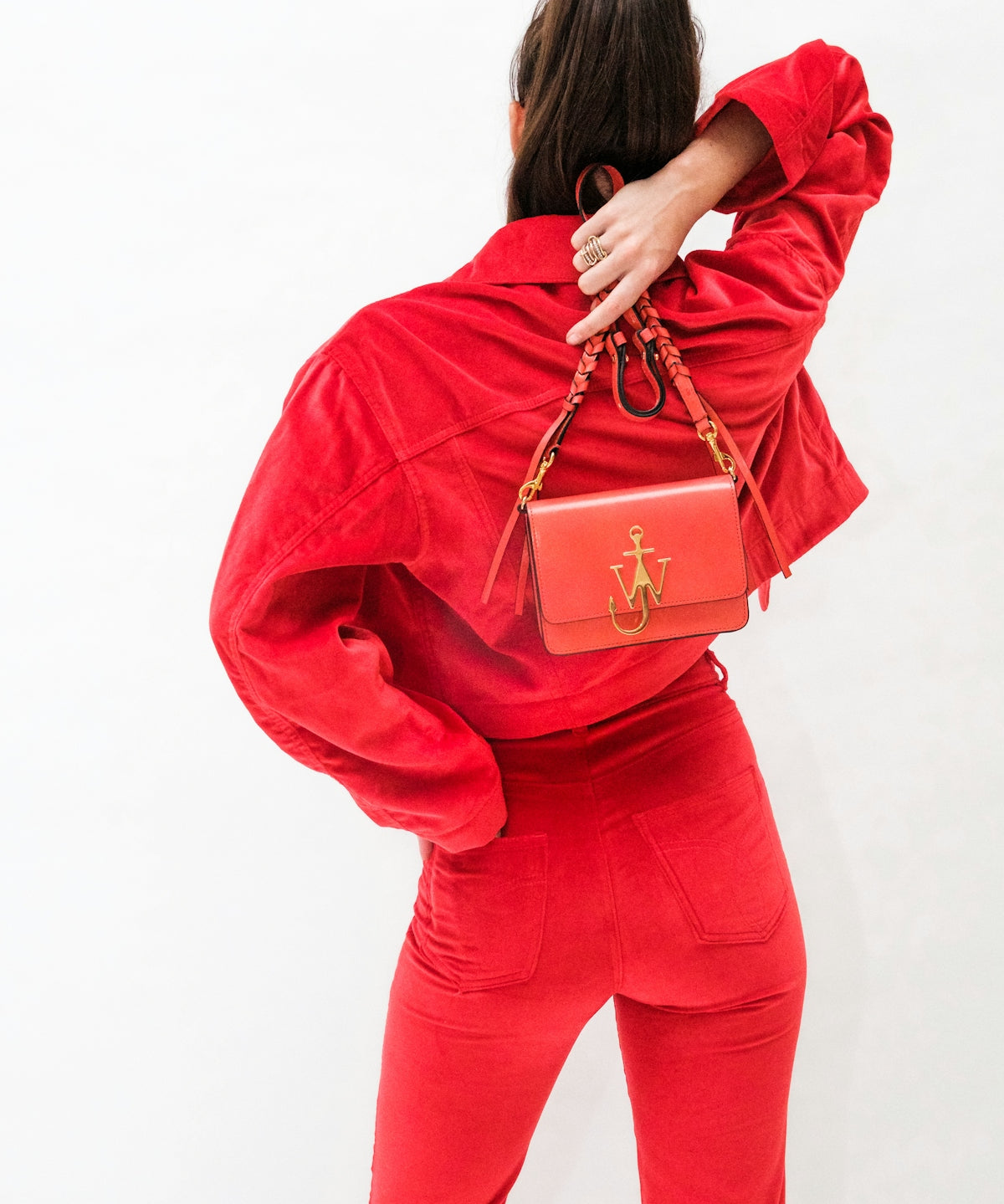 woman in red long sleeve shirt and red pants carrying brown leather handbag
