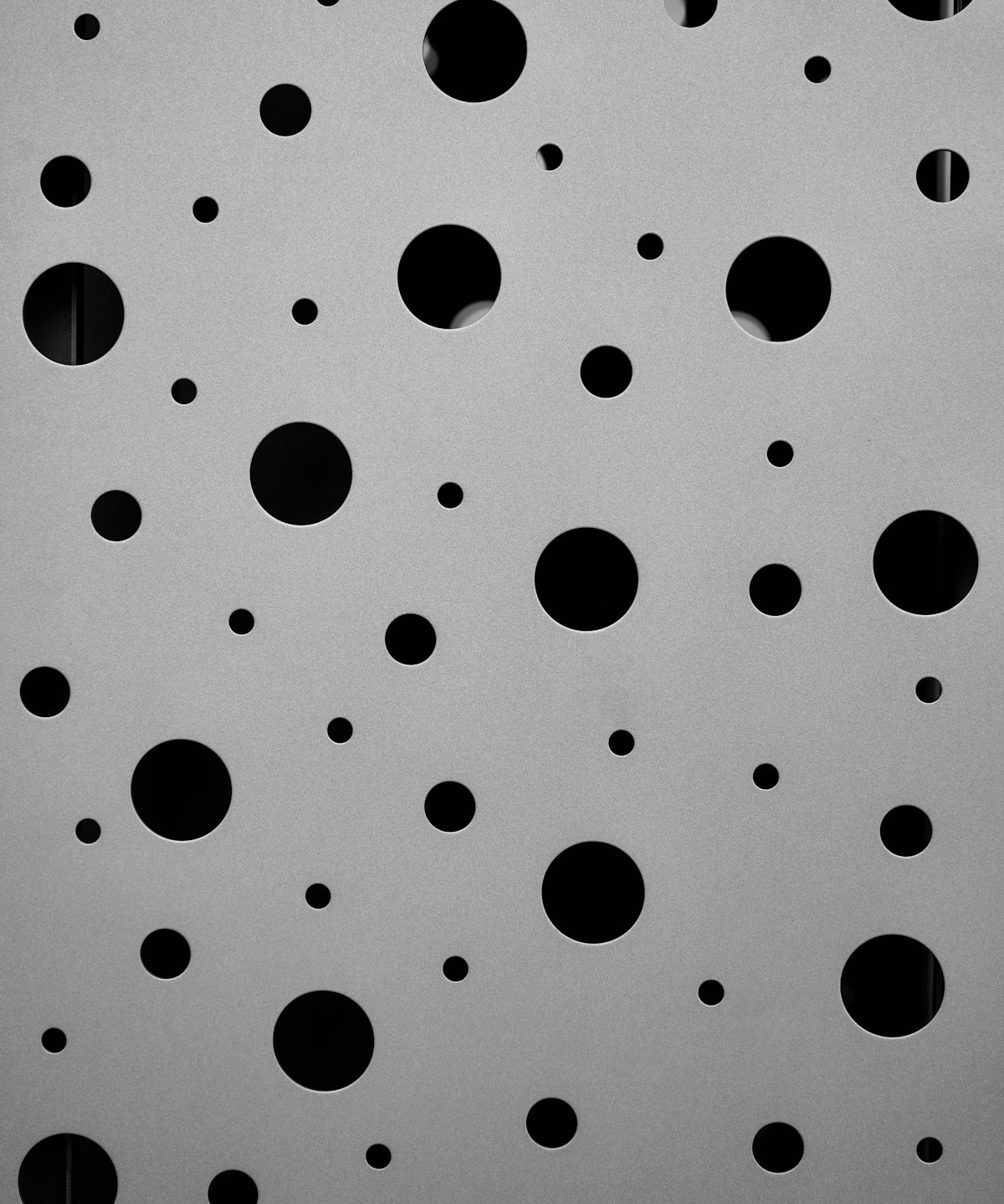 a black and white photo of circles on a wall
