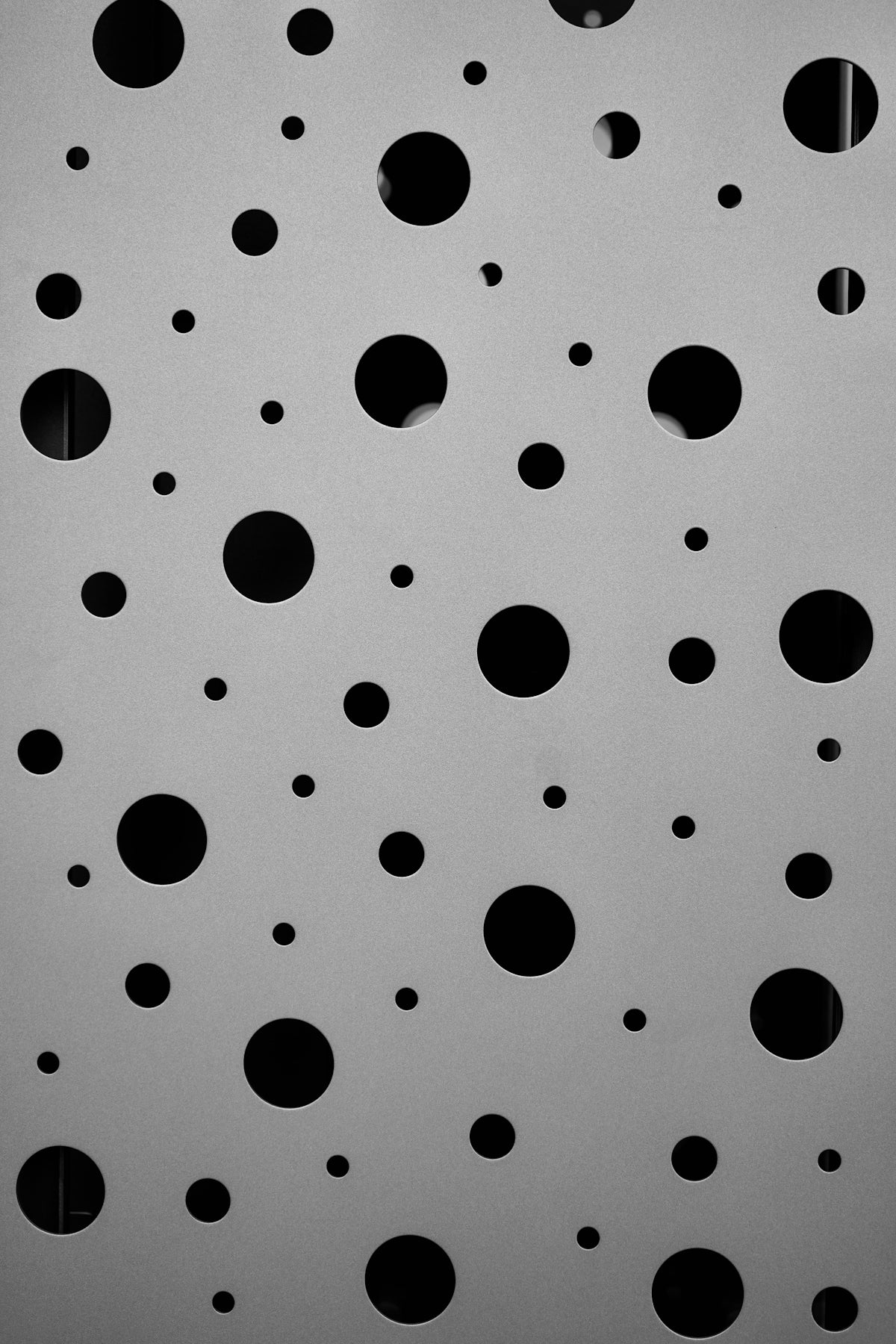 a black and white photo of circles on a wall
