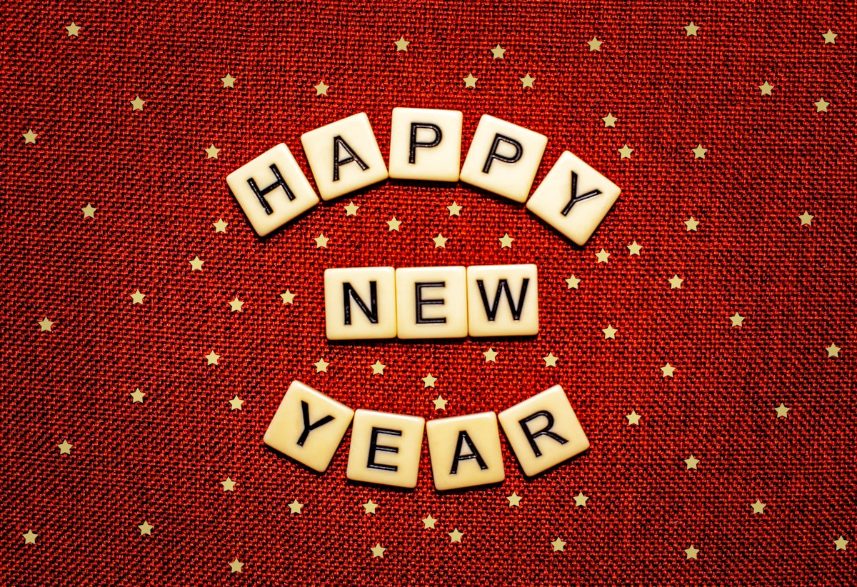 happy new year spelled with scrabbles on a red background
