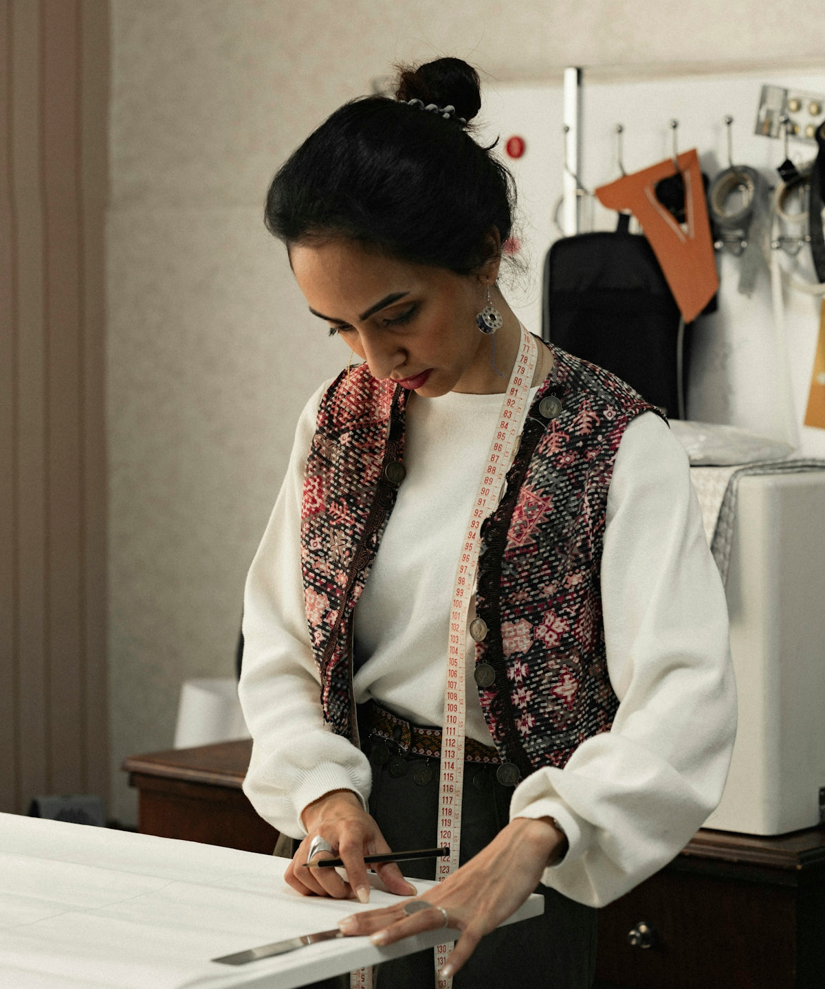 a woman in a white shirt and black pants holding a piece of paper