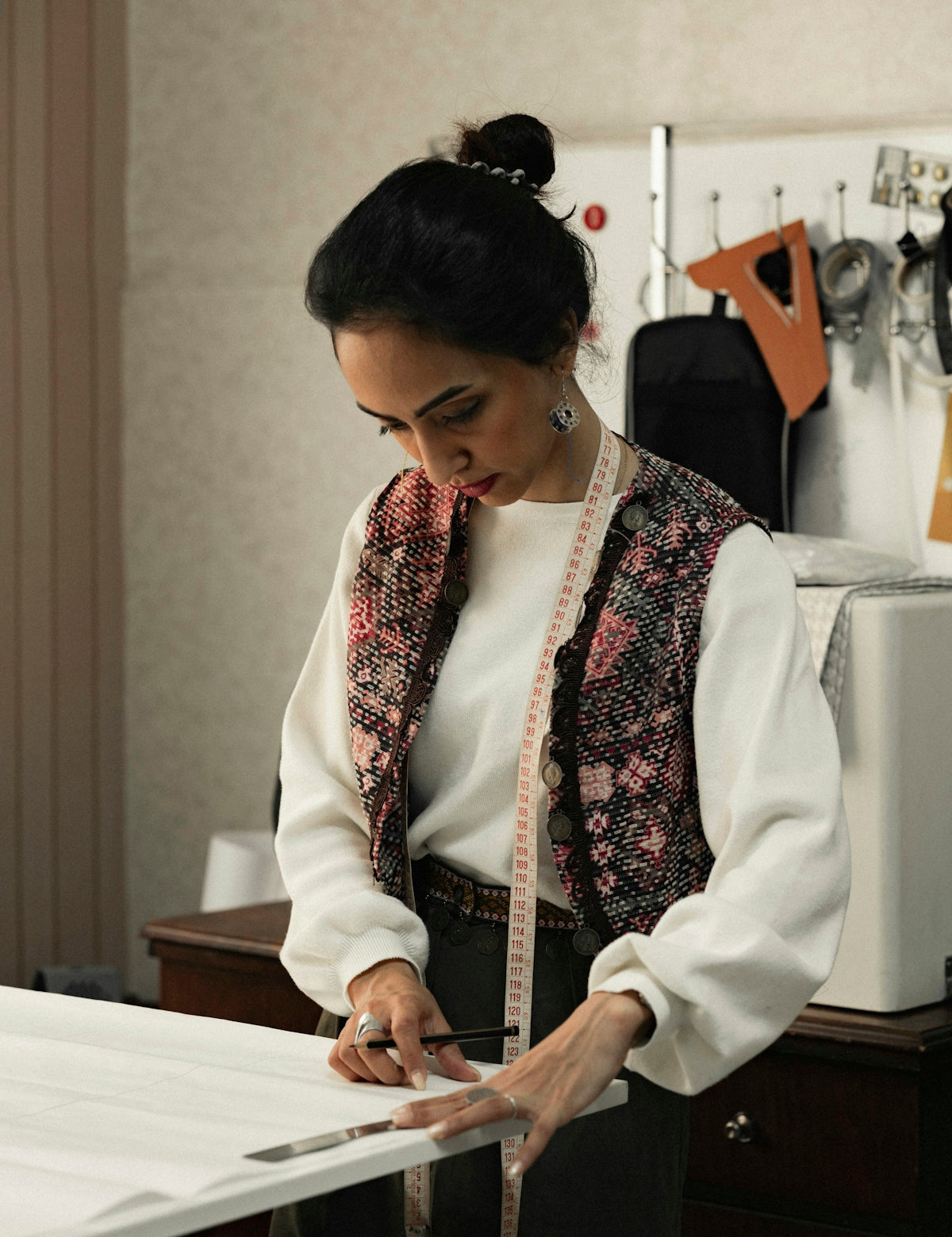 a woman in a white shirt and black pants holding a piece of paper