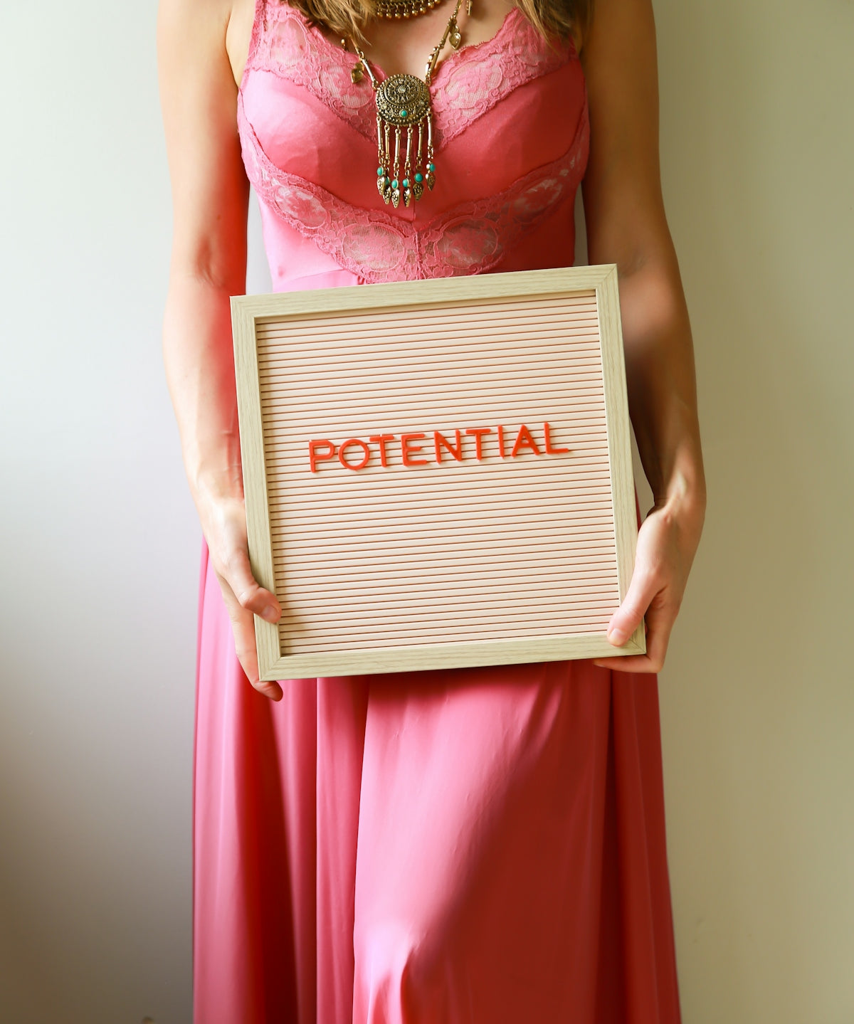 Woman holds a sign that says potential.