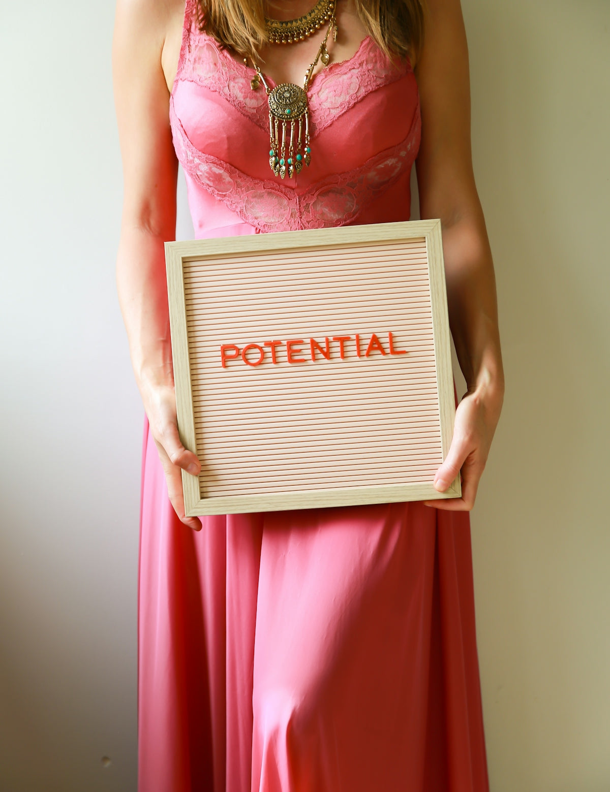 Woman holds a sign that says potential.