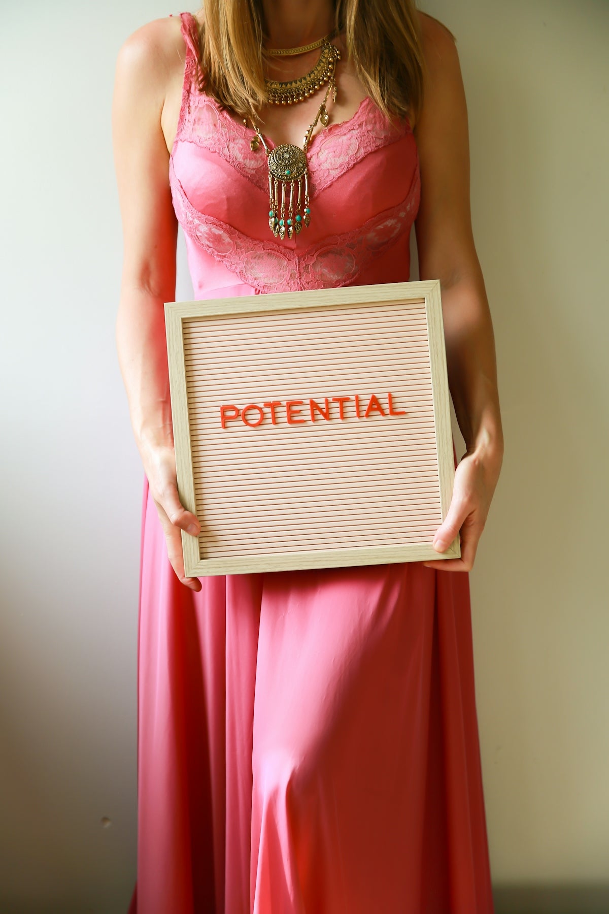 Woman holds a sign that says potential.