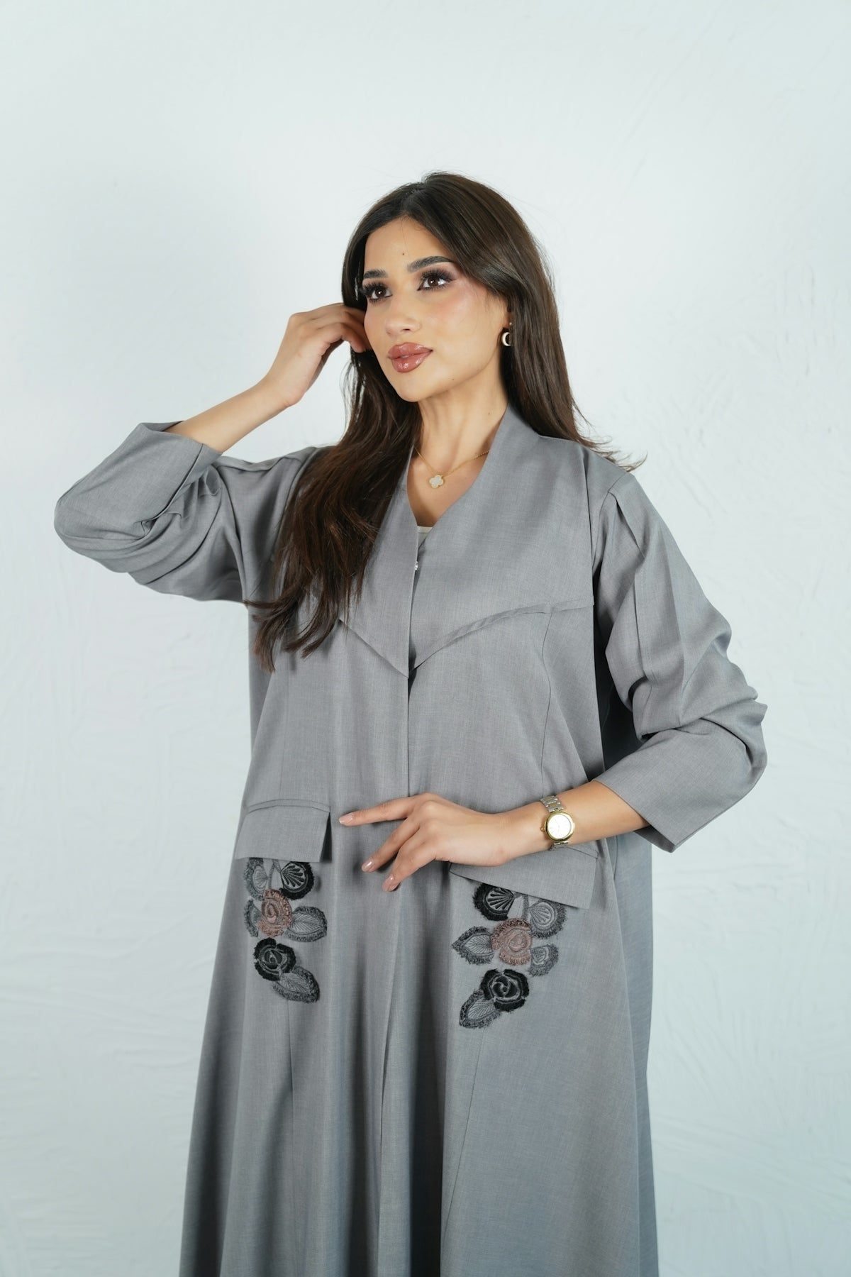 Woman wearing a stylish gray abaya.
