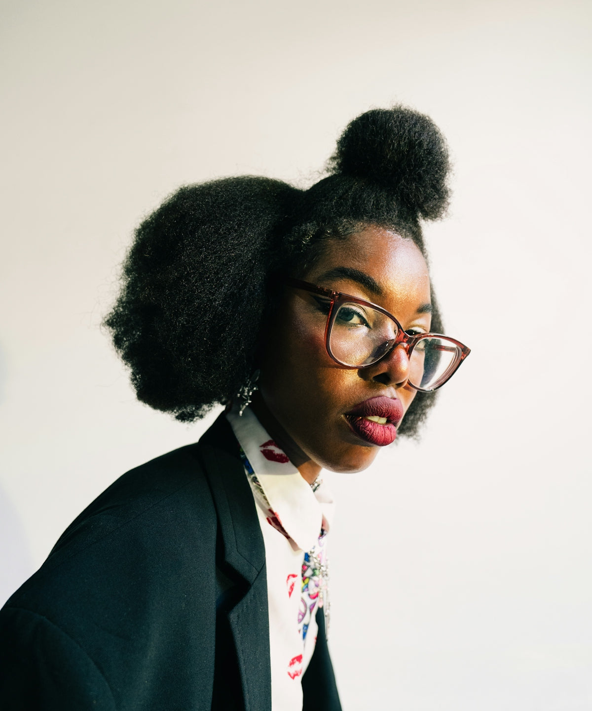 Woman with glasses and styled hair wearing a blazer