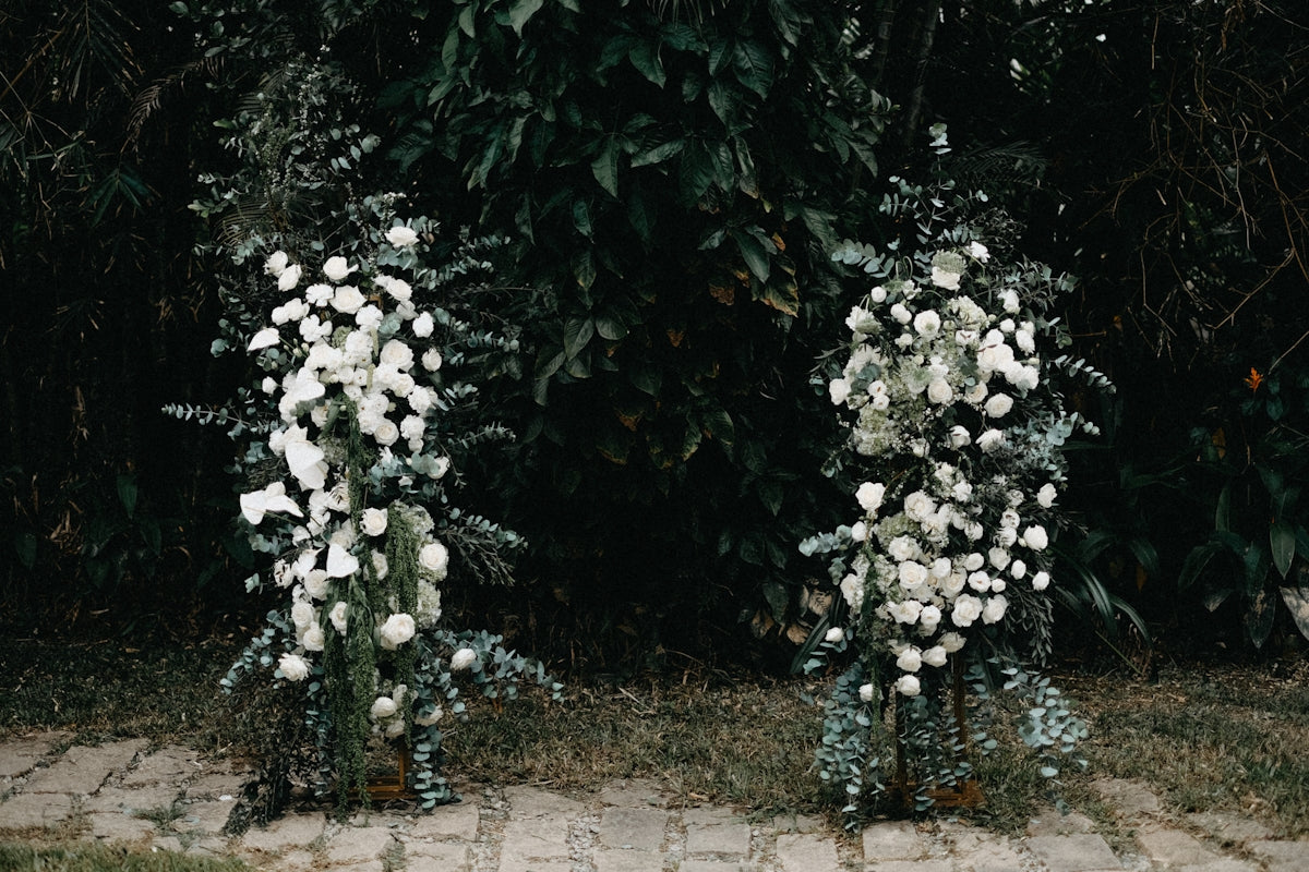 Two floral arrangements with white flowers and greenery
